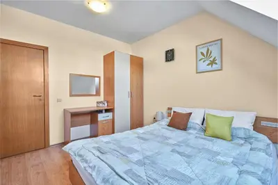 a bedroom with a large bed and a desk at Charming 1-Bedroom Apartment in Ravda by Flat Mаnаger in Nesebar