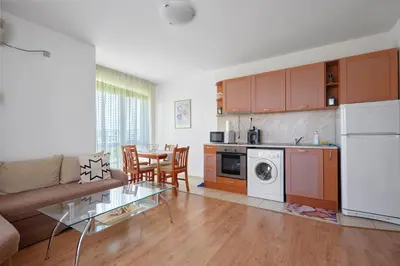 a kitchen and living room with a couch and a table at Charming 1-Bedroom Apartment in Ravda by Flat Mаnаger in Nesebar