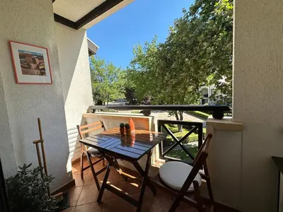 a table and chairs on the balcony of a house at Seaside Oasis Apartment in Lozenets