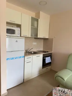 a kitchen with white cabinets and a sink and a microwave at Apartment Premier Fort Beach hotel F1 420 in Sveti Vlas