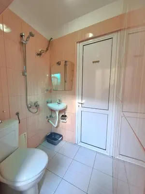 a bathroom with a toilet and a shower and a sink at Mateo Center in Varna City
