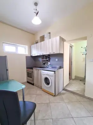a kitchen with a washing machine and a table at Mateo Center in Varna City