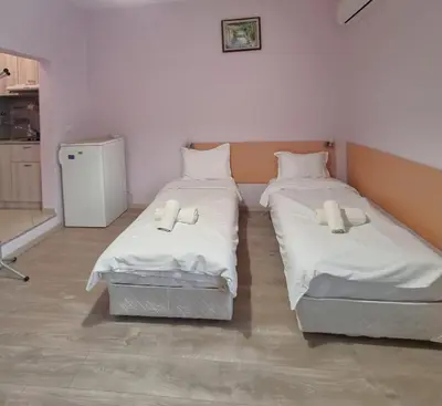 two beds in a room with white sheets at Mateo Center in Varna City