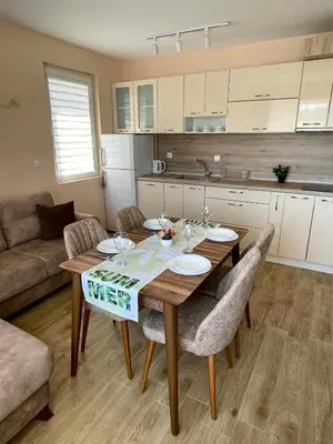 a kitchen and dining room with a table and chairs at Garmanovi Apartment in Sozopol, with free parking in Sozopol