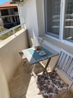a table and two chairs sitting on a balcony at Garmanovi Apartment in Sozopol, with free parking in Sozopol