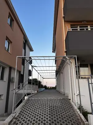 a cobblestone alley between two buildings at Garmanovi Apartment in Sozopol, with free parking in Sozopol