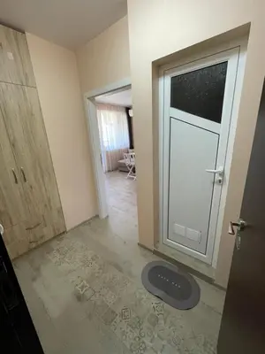 an empty room with a door and a rug in front of it at Sunset studio in Sozopol, with free parking in Sozopol