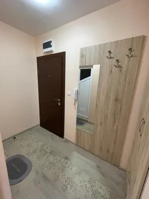 a bathroom with a wooden door and a mirror at Sunset studio in Sozopol, with free parking in Sozopol