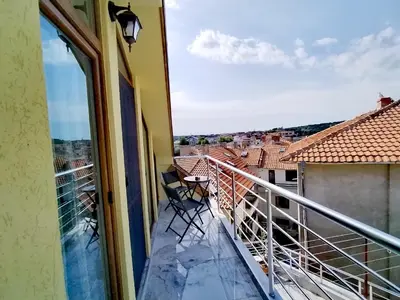a balcony with a view of a city at Стаи за гости Гергана град Созопол in Sozopol