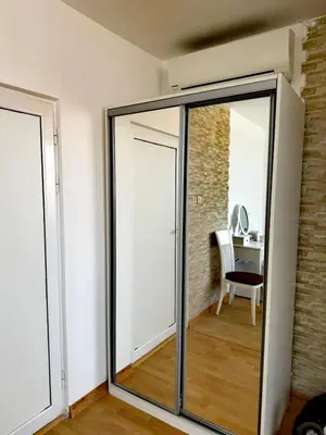a sliding glass door in a room with a table at Стаи за гости Гергана град Созопол in Sozopol