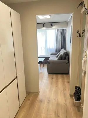 a living room with a couch and a table at Varna central apartment with parking for normal to middle sized cars in Varna City