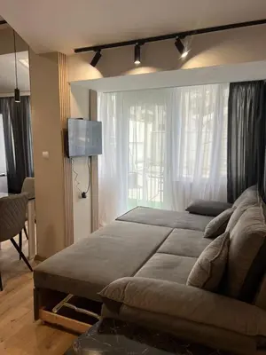 a bedroom with a large bed and a window at Varna central apartment with parking for normal to middle sized cars in Varna City