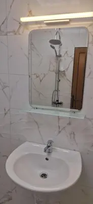 a bathroom sink with a mirror and a shower at Отличен Двустаен Апартамент in Primorsko