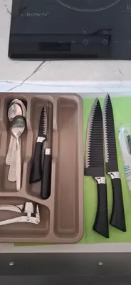 a tray of utensils sitting on a table at Отличен Двустаен Апартамент in Primorsko