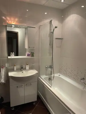 a bathroom with a sink and a shower and a tub at Apartment in Long Beach in Shkorpilovtsi