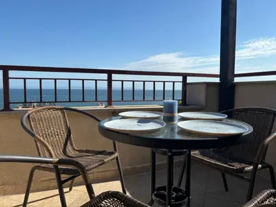 a table and chairs on a balcony with a view at Sozopol Paradise view in Sozopol