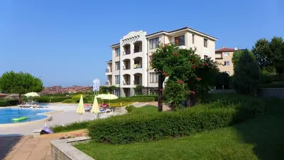 a large white building with a pool in front of it at Sozopol Paradise view in Sozopol
