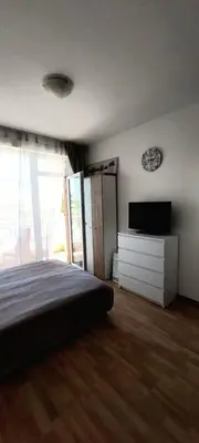 a bedroom with a bed and a flat screen tv at Studio in Sunny day 6 complex in Sunny Beach