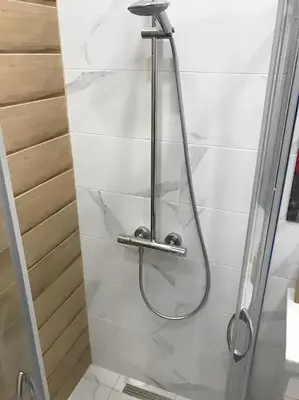 a shower with a shower head in a bathroom at HOT Main Square Newly Built Modern Apartment in Burgas City