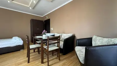 a living room with a table and a couch at Bratanov Bahami Residence Studio in Sunny Beach