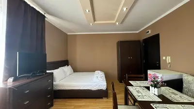 a small room with a bed and a dining table at Bratanov Bahami Residence Studio in Sunny Beach
