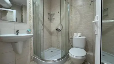 a bathroom with a shower and a toilet and a sink at Bratanov Bahami Residence Studio in Sunny Beach