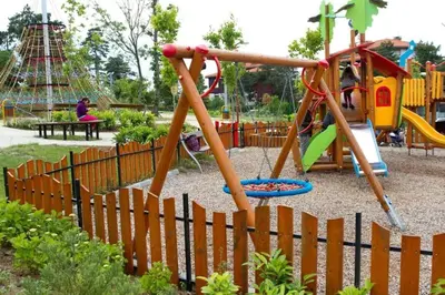 a playground in a park with a wooden fence at 1 Apartment Verano Del Mar Sozopol in Sozopol