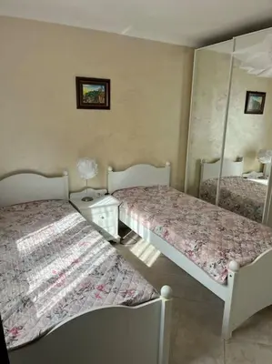 a bedroom with two beds and a mirror at 2 Apartment Verano Del Mar Sozopol in Sozopol
