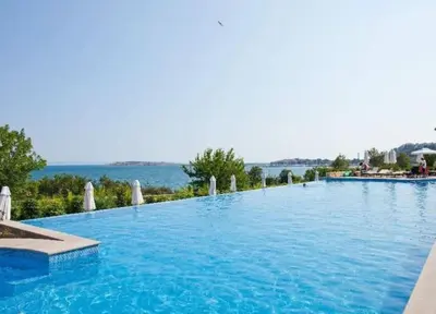 a large swimming pool with blue water at 2 Apartment Verano Del Mar Sozopol in Sozopol