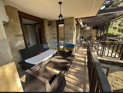 a porch with a bed and chairs on a balcony at 2 Apartment Verano Del Mar Sozopol in Sozopol