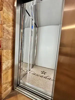 a glass elevator with the door open in a room at Studio at Kaskadas A44 in Sunny Beach