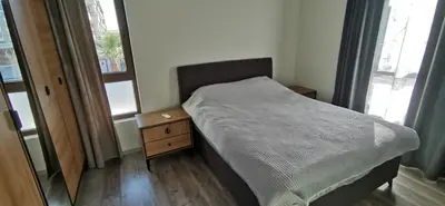a small bedroom with a bed and a night stand at Aх, морето in Burgas City