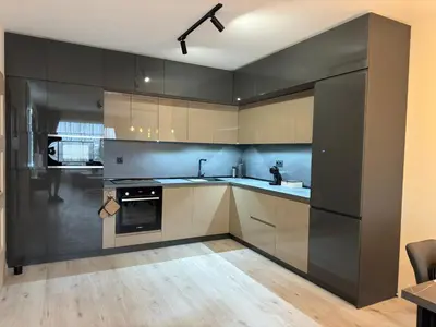 a kitchen with black cabinets and an oven at South Bay Luxury Apartment in Varna City
