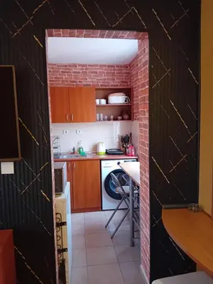 a kitchen with a brick wall at Laura 2 in Primorsko