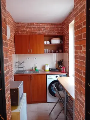 a kitchen with a brick wall at Laura 2 in Primorsko