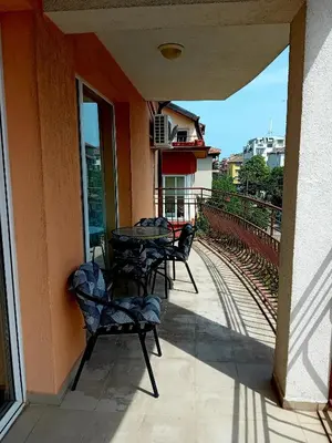 a patio with tables and chairs on a balcony at Laura 2 in Primorsko