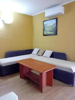 a living room with a couch and a table at Laura 2 in Primorsko