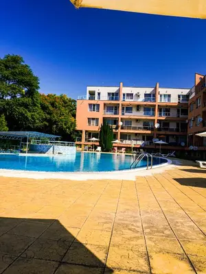 a large swimming pool in front of a building at Jolly apartments in Nesebar
