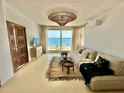 a living room with a couch and a large window at Casa de oro Lujo in Sozopol