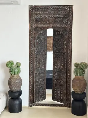 an ornate mirror with two vases on a table next to a mirror with at Casa de oro Lujo in Sozopol