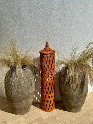 three vases with plants in them on a table at Casa de oro Lujo in Sozopol