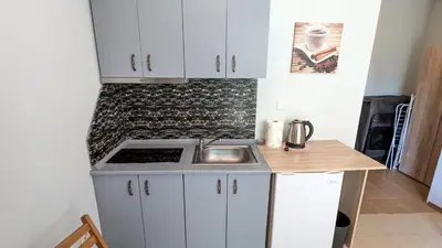 a small kitchen with a sink and a stove at Studio in the Center of Sunny Beach by Flat Mаnаger in Sunny Beach
