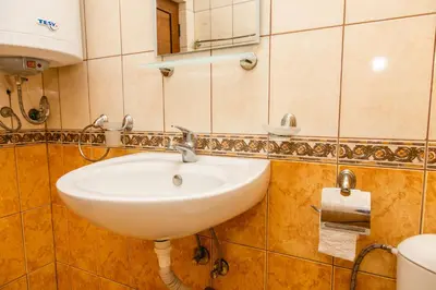 a bathroom with a white sink and a mirror at Studio in the Center of Sunny Beach by Flat Mаnаger in Sunny Beach