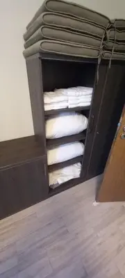 a cabinet filled with white pillows in a room at Cascadas Victory Suite Ravda in Ravda