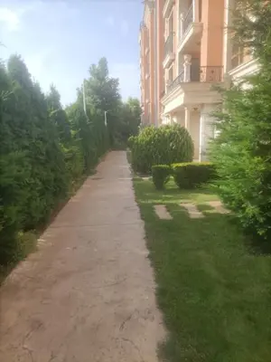 a sidewalk in front of a building next to a building at Cascadas Victory Suite Ravda in Ravda