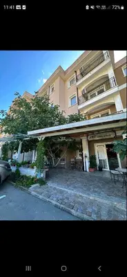 a large building with a car parked in front of it at Studio Anelia in Sveti Vlas