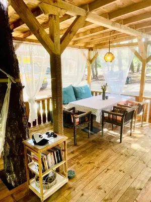 a living room with a table and a couch at Каравана Безвремие in Chernomorets