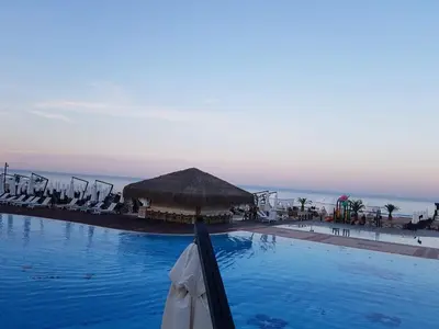a large swimming pool with chairs and a gazebo at Bogdanov in Lozenets
