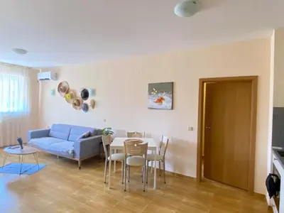a living room with a blue couch and a table at the magic dream, Sveti Vlas in Sveti Vlas
