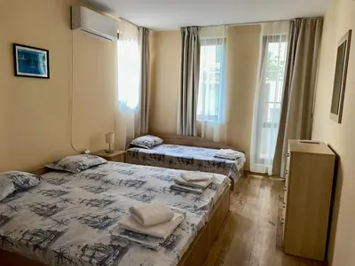 two beds in a room with two windows at Sozopol Dreams - Apartment 1 in Sozopol